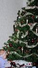 baby-touching-heart-ornament-on-christmas-tree.jpg